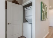 Thumbnail 23 of 43 - a white washer and dryer in a kitchen with a white door