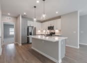Thumbnail 16 of 43 - a kitchen with an island and a refrigerator and a sink