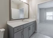 Thumbnail 29 of 43 - a bathroom with a sink and a mirror