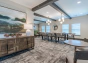 Thumbnail 9 of 43 - a dining room with tables and chairs and a large painting on the wall
