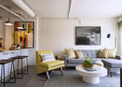 Thumbnail 7 of 31 - a living room with a gray couch and a yellow chair
