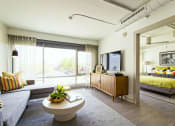 Thumbnail 6 of 31 - a living room with a couch and a coffee table    and a bedroom