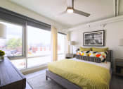 Thumbnail 9 of 31 - a bedroom with a bed and a large window