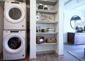 Thumbnail 11 of 31 - a washing machine and a dryer in a laundry room