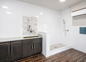 Thumbnail 23 of 31 - A bathroom with a shower and a sink.