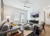 Thumbnail 4 of 24 - a living room with a couch and a tv