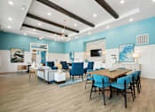 Thumbnail 10 of 24 - A modern dining room with a wooden table and blue chairs.