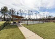 Thumbnail 18 of 22 - the pavilion overlooking the tennis courts at the whispering winds apartments in pearland