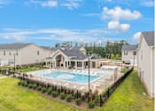 Thumbnail 61 of 65 - A pool surrounded by a black fence with a house in the background.