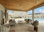 Thumbnail 52 of 65 - A patio with a pool and a ceiling fan.