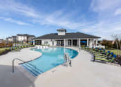Thumbnail 22 of 22 - the preserve at ballantyne commons pool with lounge chairs and a building