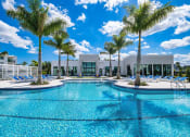 Thumbnail 43 of 78 - a swimming pool at a resort with palm trees at Altis Blue Lake, Lake Worth, Florida
