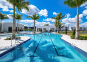 Thumbnail 47 of 78 - a large swimming pool with palm trees and buildings in the background at Altis Blue Lake, Lake Worth, Florida