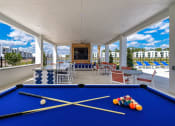 Thumbnail 40 of 78 - a games room with a pool table and chairs at Altis Blue Lake, Florida, 33467
