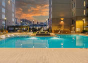 Thumbnail 41 of 47 - Luxury Apartments For Rent In Atlanta, GA - Venue Brookwood - Saltwater Pool With Spacious Sundeck, Submerged And Poolside Lounge Chairs, And Fountain.