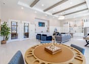 Thumbnail 16 of 40 - A modern living room with a wooden coffee table in the center.