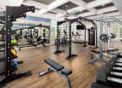 Thumbnail 6 of 27 - Ridgeville, SC, Luxury Apartments with In-Unit Washer and Dryer - Preserve at Ridgeville - Fitness Center with Large Windows, Oversized Mirror, Dumbbells, Weights, and Cardio Machines.