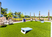 Thumbnail 30 of 40 - A backyard with a white lawn chair and a blue table.