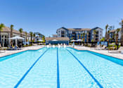 Thumbnail 32 of 40 - A large swimming pool in front of a resort.