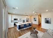 Thumbnail 18 of 32 - A modern kitchen with a dining table and chairs.