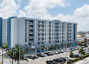 Thumbnail 35 of 35 - A large building with a parking lot in front of it.