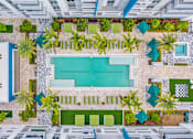 Thumbnail 28 of 35 - a pool area of a hotel with a swimming pool and palm trees