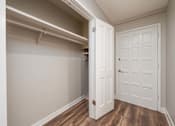 Thumbnail 30 of 48 - A white door is in a room with wood flooring.