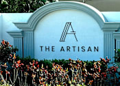 Thumbnail 33 of 38 - A white sign with a black letter A and the words "The Artisan" in front of some plants.