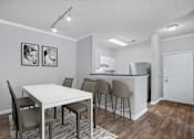 Thumbnail 3 of 29 - A kitchen with a dining table and chairs.
