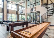 Thumbnail 7 of 49 - a game room with a pool table and a spiral staircase