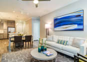 Thumbnail 21 of 49 - a living room and dining room area with a couch and a table