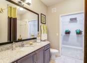 Thumbnail 25 of 49 - a bathroom with a large mirror and a toilet and a shower