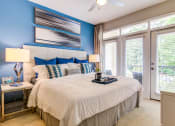 Thumbnail 23 of 49 - a bedroom with a large bed and a large window