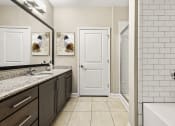 Thumbnail 33 of 49 - a bathroom with a sink and a shower and a white door