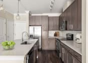 Thumbnail 26 of 49 - Luxury Apartments in Decatur, GA, With In-Unit Washer and Dryer - Reserve Decatur - Kitchen With Quartz Countertops, Under Mount Sink, Stainless Steel Appliances, Subway Style Backsplash