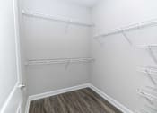 Thumbnail 35 of 49 - Empty white shelves in a room with wood flooring.