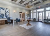 Thumbnail 8 of 44 - Leasing Office and Clubhouse with White Armchairs on Area Rug with Coffee Tables at Residence at Midland, Midland, 79706