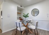 Thumbnail 4 of 28 - a dining room with a glass table and chairs