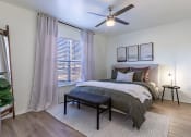 Thumbnail 10 of 28 - a bedroom with a bed and a ceiling fan