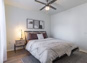 Thumbnail 11 of 28 - a bedroom with a bed and a ceiling fan