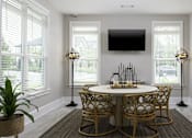 Thumbnail 14 of 32 - A dining room with a round table and chairs.