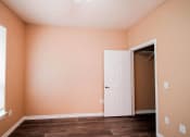 Thumbnail 46 of 69 - a room with a closet and a window and a door