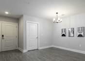 Thumbnail 12 of 32 - A room with a white door, a white wall, and a chandelier.