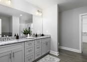 Thumbnail 9 of 32 - A bathroom with a vanity and a mirror.