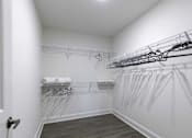 Thumbnail 11 of 32 - A white closet with a white door and a white towel on a shelf.