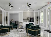 Thumbnail 13 of 32 - A living room with a white ceiling and a fireplace.