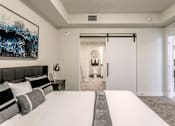 Thumbnail 21 of 30 - A bedroom with a large bed and a painting on the wall at Saba Pompano Beach, Pompano Beach, 33062