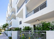 Thumbnail 27 of 30 - A white building with balconies and plants in front at Saba Pompano Beach, Pompano Beach, 33062