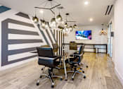 Thumbnail 8 of 30 - A conference room with a striped wall and a television mounted on the wall at Saba Pompano Beach, Pompano Beach, 33062