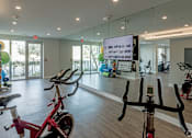 Thumbnail 15 of 30 - A gym with exercise bikes and a mirror at Saba Pompano Beach, Pompano Beach, 33062